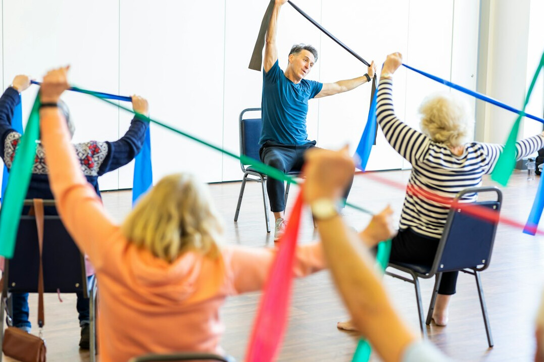 elderly people exercising together