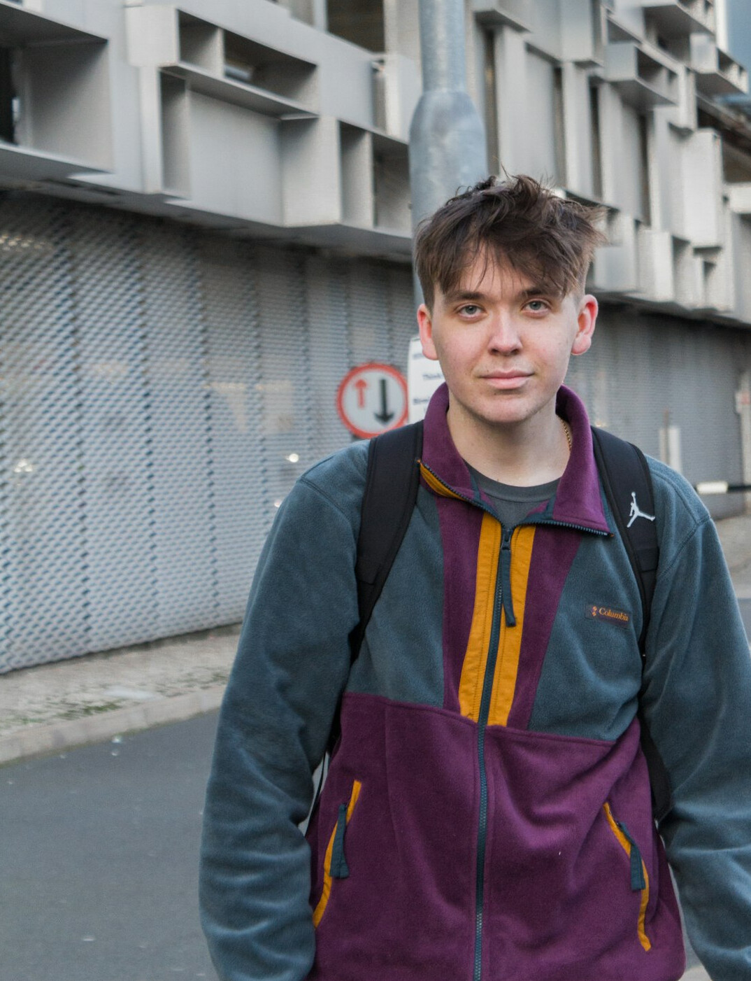 Portrait of a 39 year old man with short dark hair and a friendly smile wearing a sports jacket